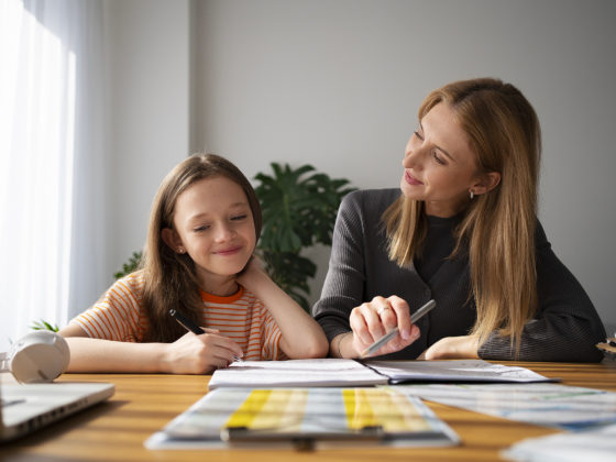 teacher helping girl learning english