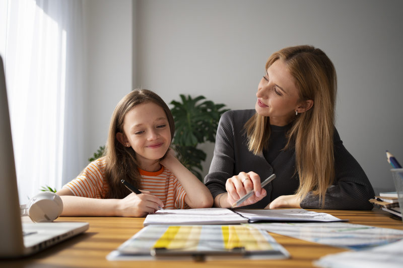 teacher helping girl learning english